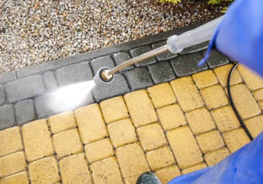 Pressure washer nozzle cleaning block paving